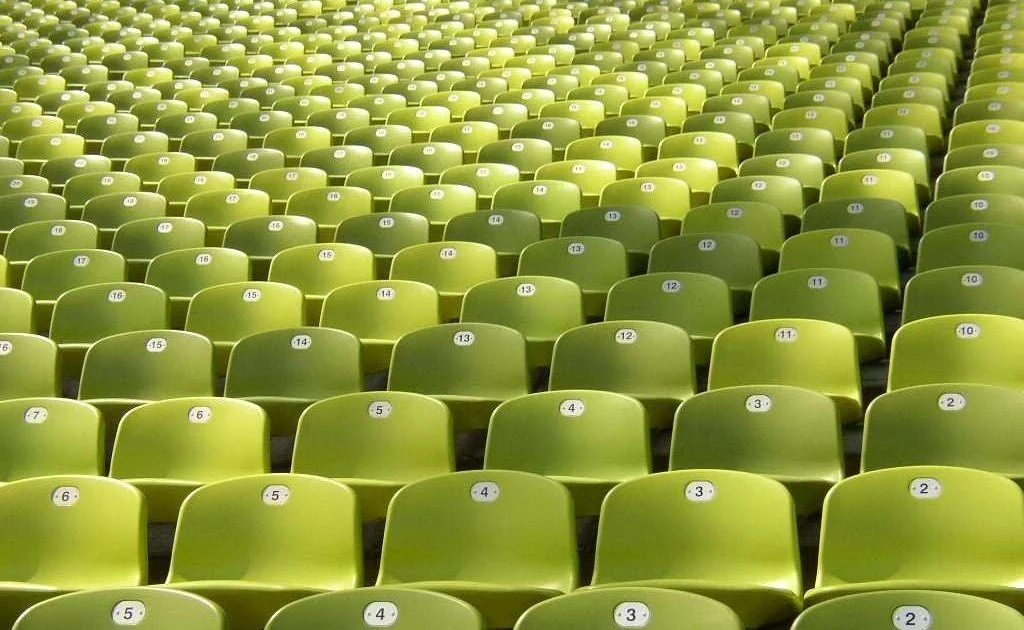 Rows of seats at an event, illustrating Terra Tag’s tips for green events and the use of sustainable plantable and recycled name badges with biodegradable lanyards"