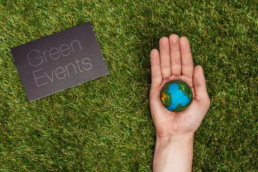 Hand holding a model of the Earth, symbolising how Terra Tag’s sustainable plantable and recycled name badges make organising green events easier and more efficient