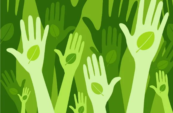 Hands holding green leaves, illustrating sustainable event tips and Terra Tag’s eco-friendly plantable and recycled name badges for environmentally conscious gatherings