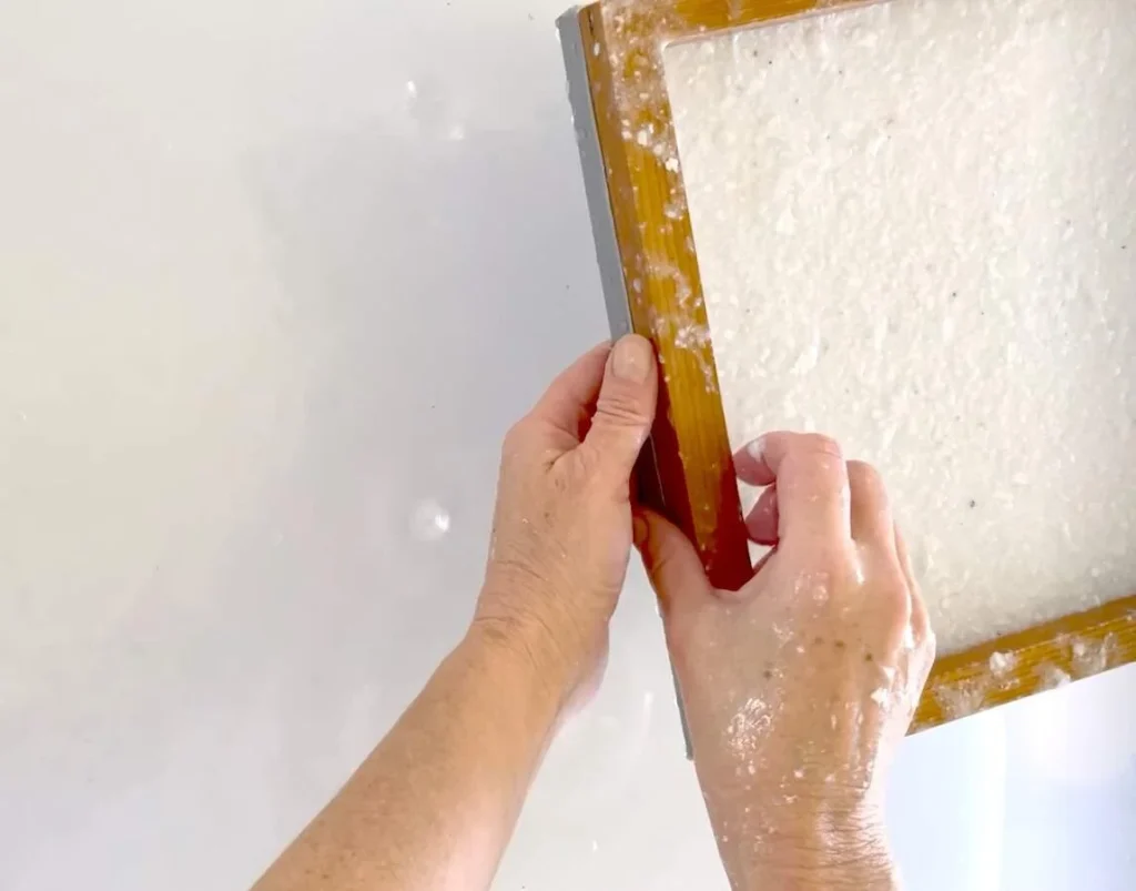 Papermaker using mould and deckle to form seed paper