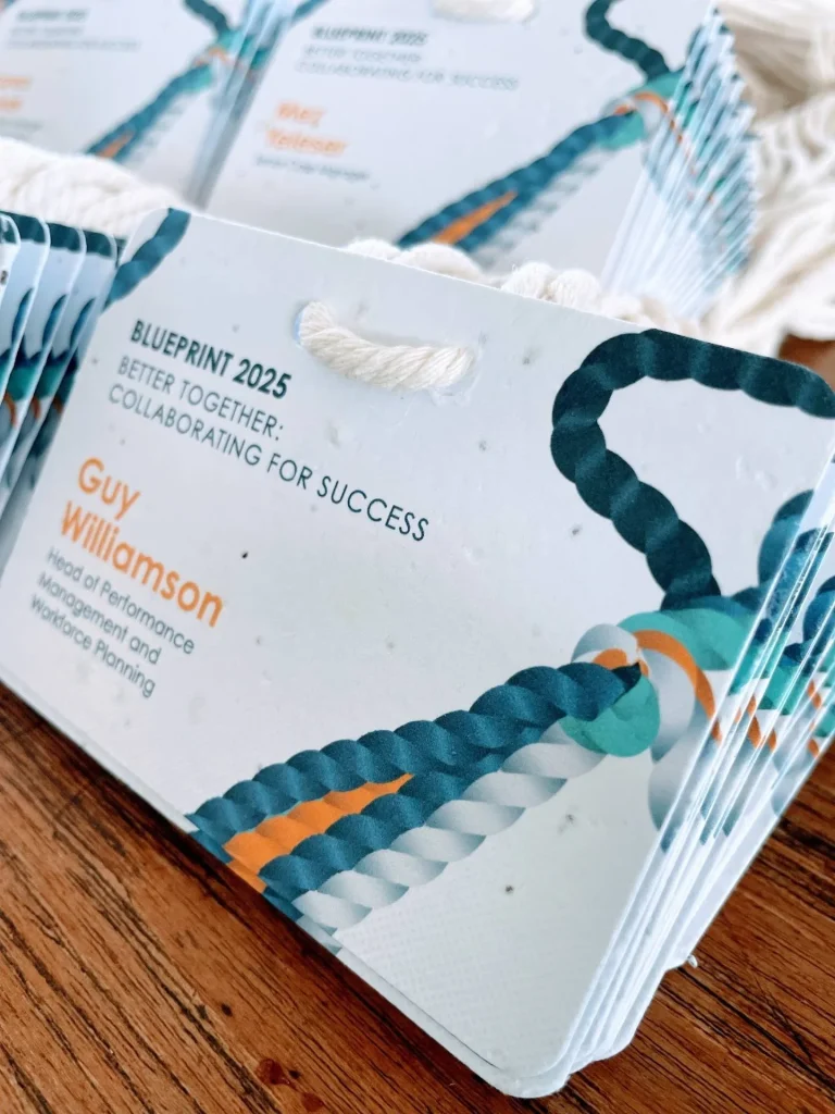 Horizontal plantable seed paper name badges by Terra Tag for a team strategy conference, featuring mixed herb seeds and eco-friendly biodegradable lanyards