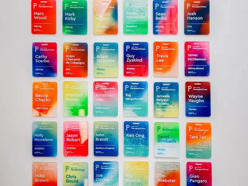 Sponsor logos positioned subtly at bottom of badge without cluttering design