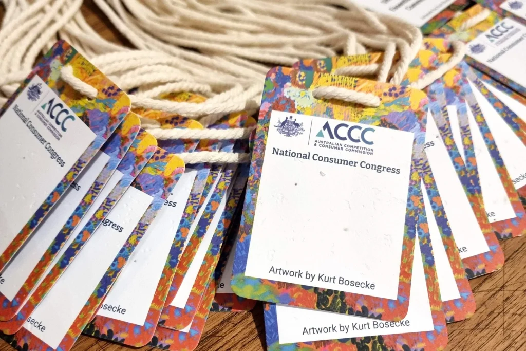 Close-up of ACCC plantable seed paper name badges by Terra Tag, showcasing eco-friendly materials, vibrant printing, and biodegradable lanyards for a zero-waste conference