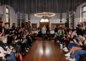 speaker at corporate event with guests wearing plantable name badges