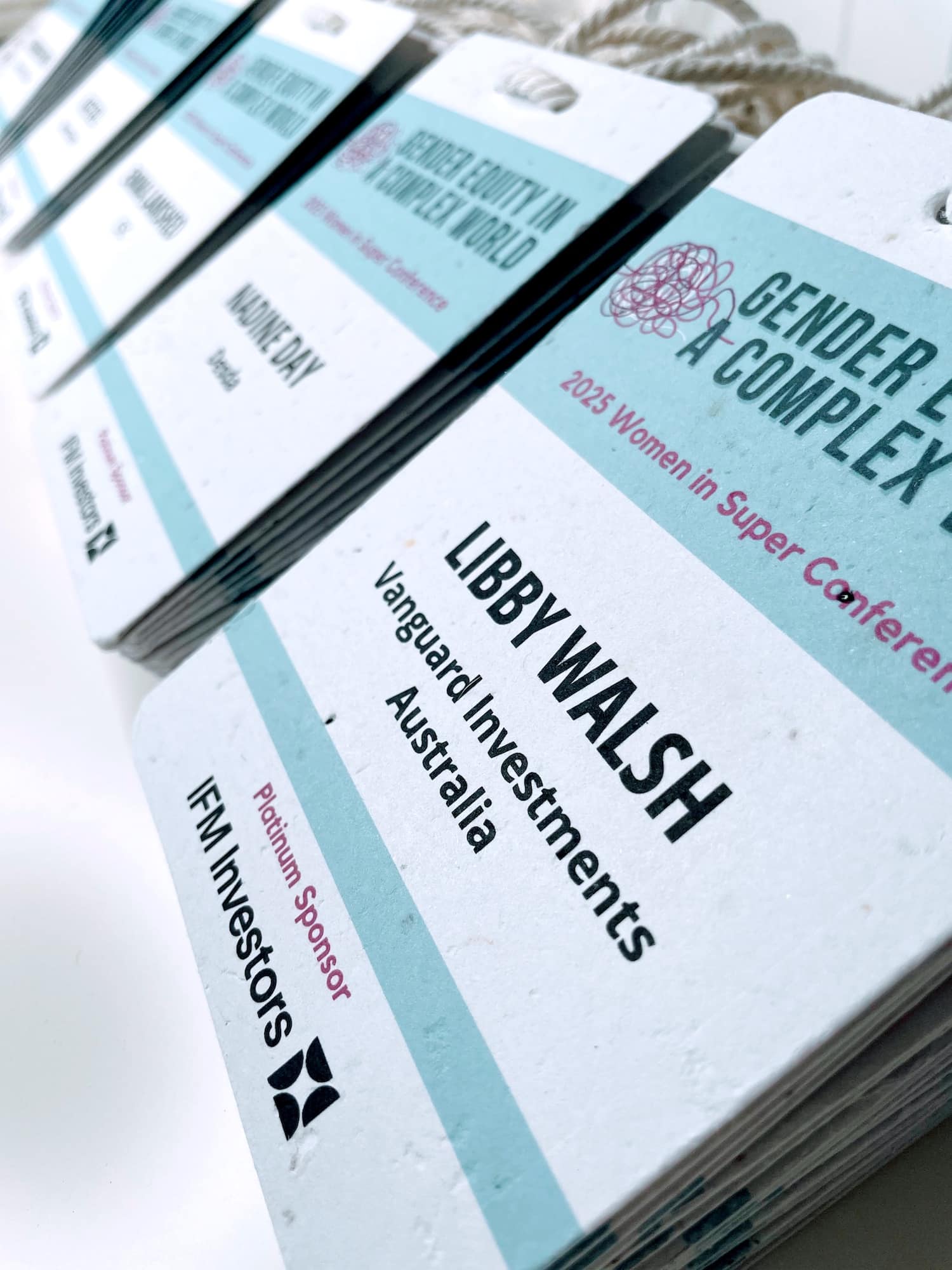 Custom event name tags on colourful seed paper with professionally designed layouts