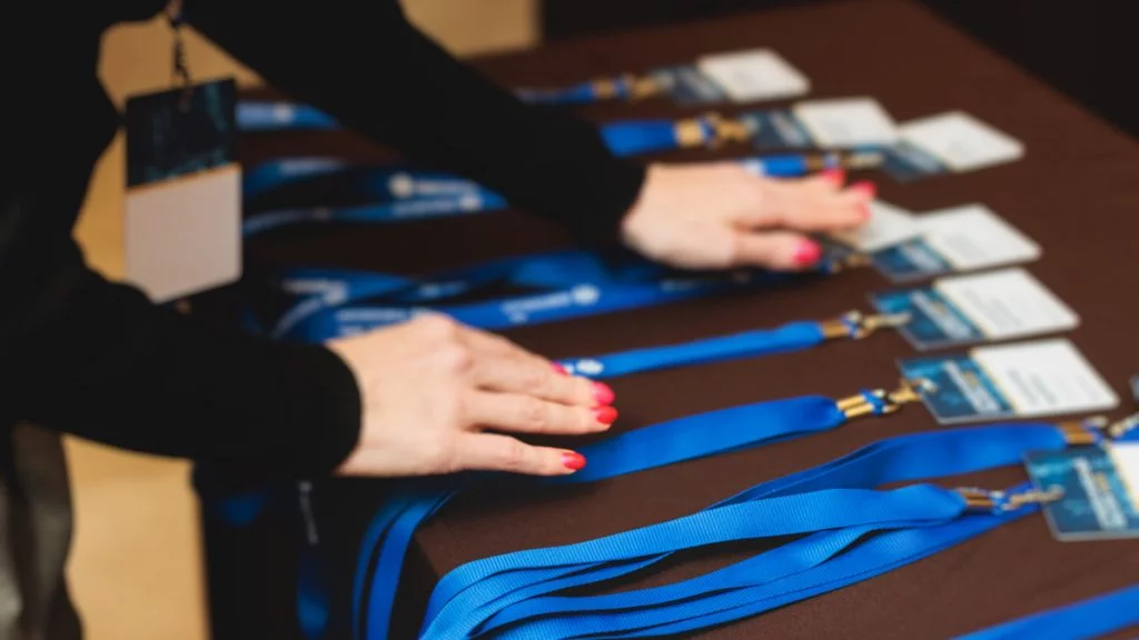 Organised registration table with compostable name badges and lanyards — smooth check-in in Australia.