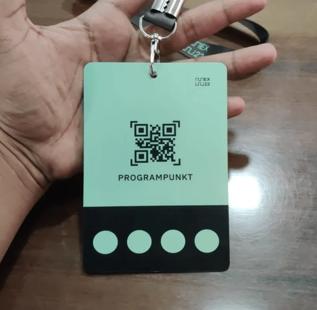 A conference name tag design with a QR code incorporated on the back with colour treatment