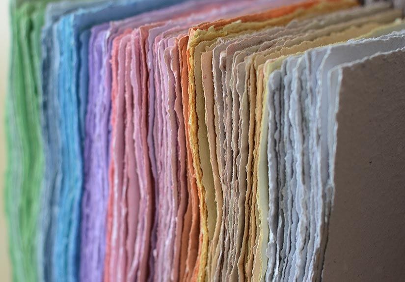 Handmade recycled paper sheets drying on a table at home