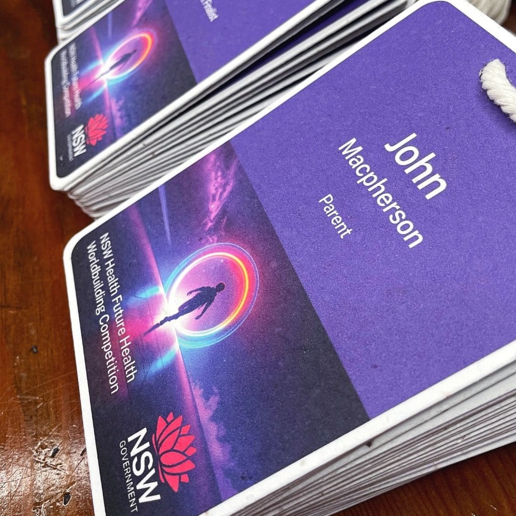Eco-friendly seed paper name badge printed for an NSW government event, showing premium colour printing on plantable stock.
