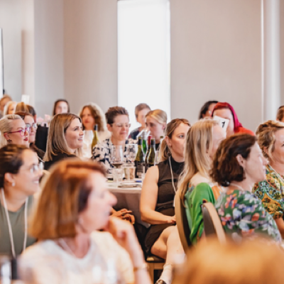 Guests wearing recycled paper name badges during an education event, showing consistent print quality and natural cotton lanyards.