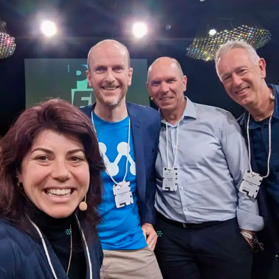 Guest wearing a recycled paper eco friendly name badge at a conference, showing the recycled stock texture and clear print.