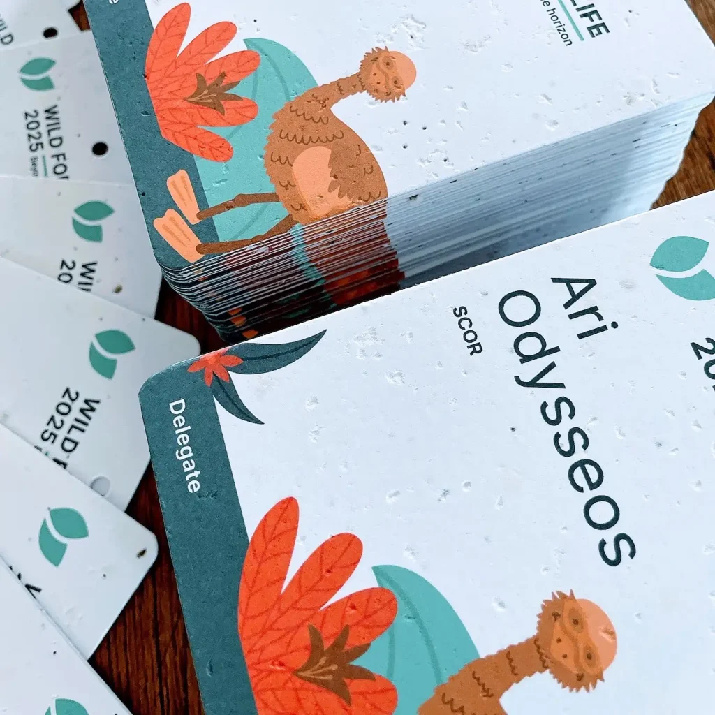 Seed paper name badge with illustrated design for insurance event, showing textured plantable stock.