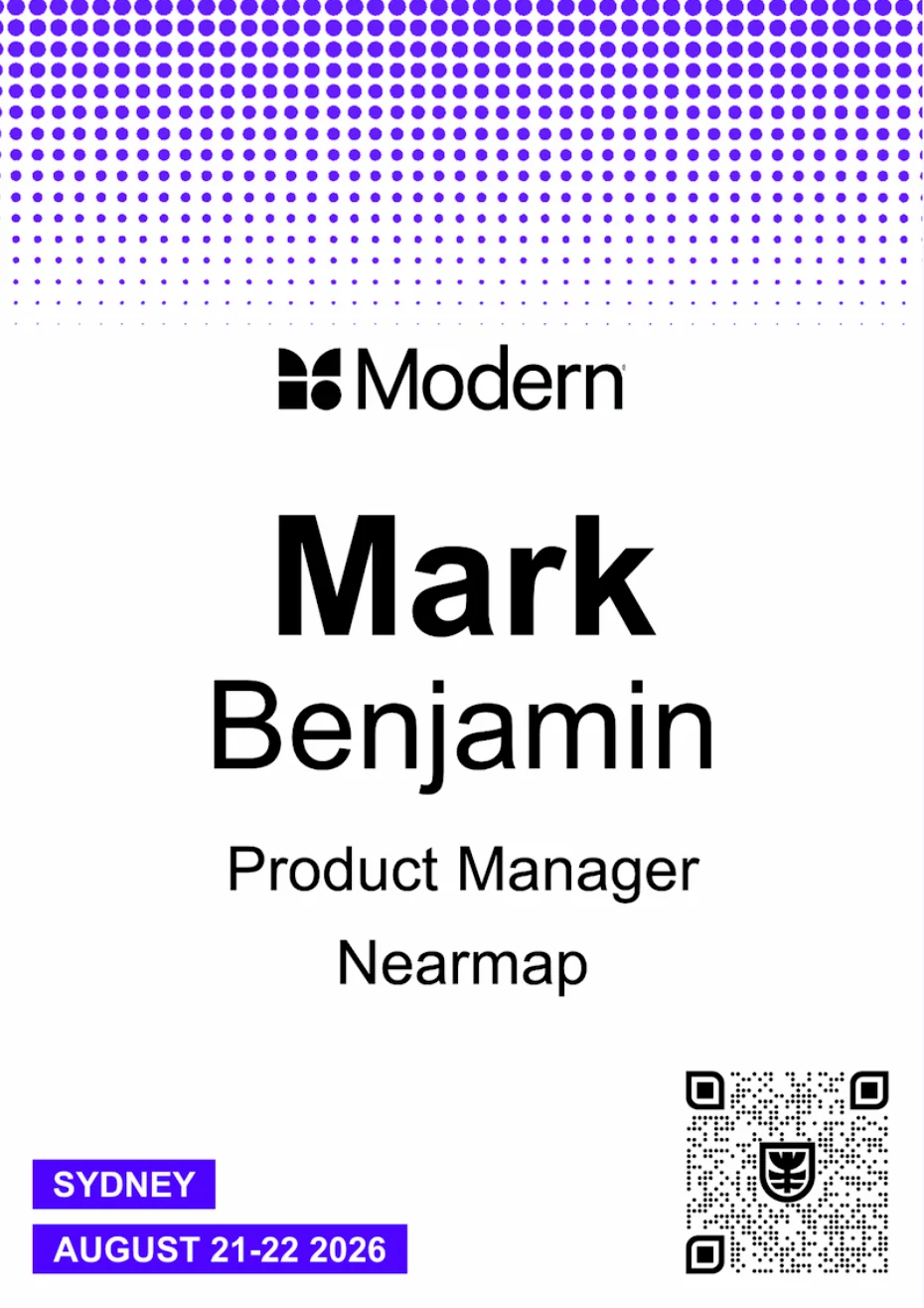 White conference name tag with a purple dot pattern, centred name, date tags and QR code